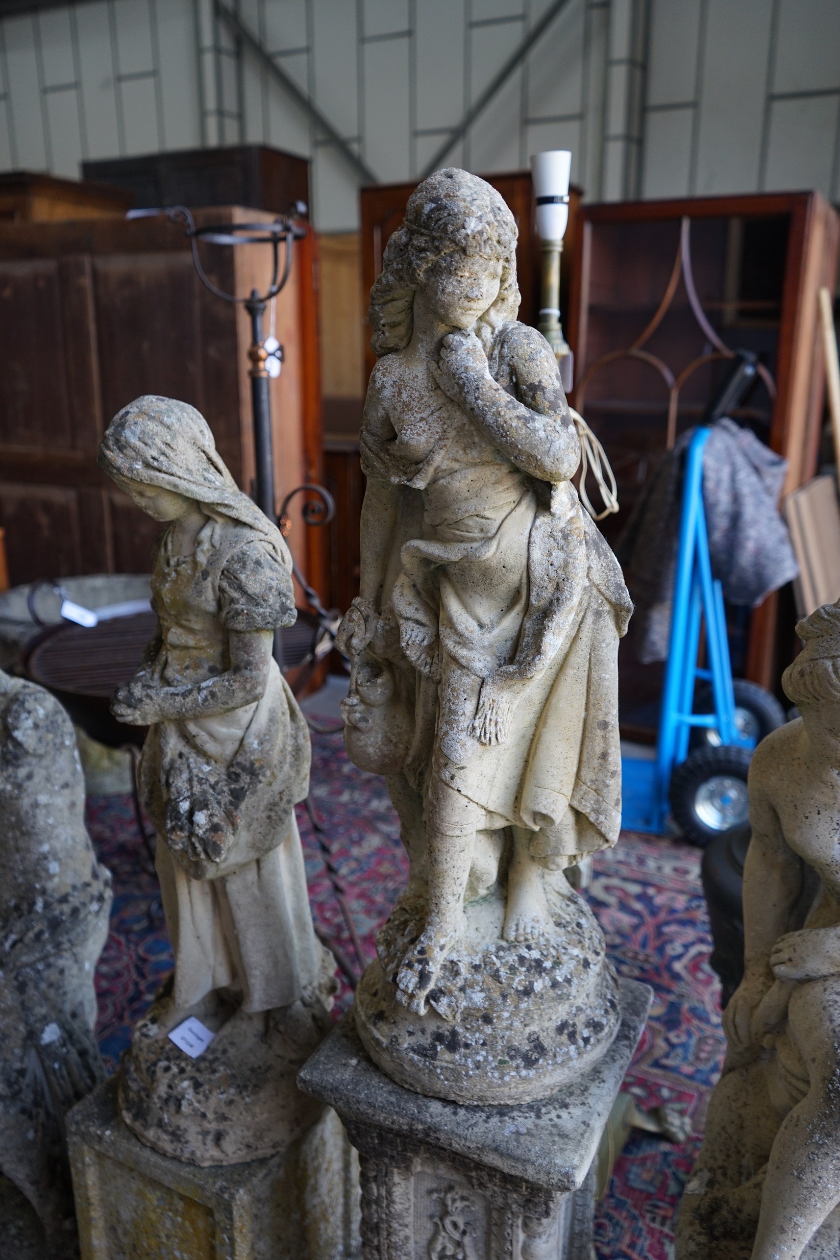 Four reconstituted stone garden statues, largest height 124cm